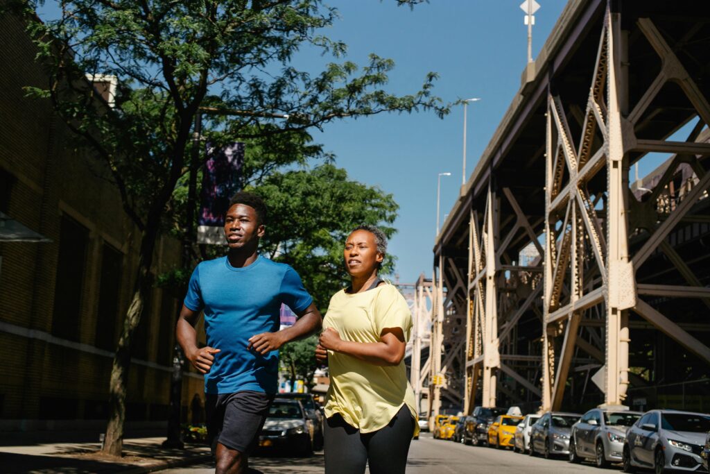 Two people running in the city.